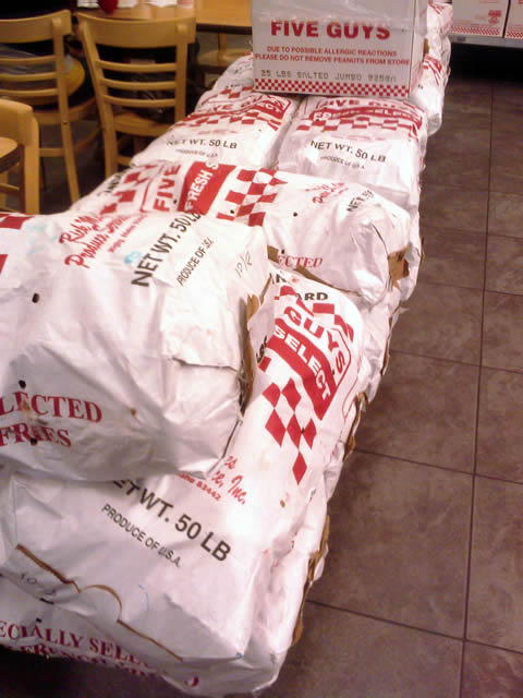 The Real Reason You Always See Bags Of Potatoes Inside Five Guys