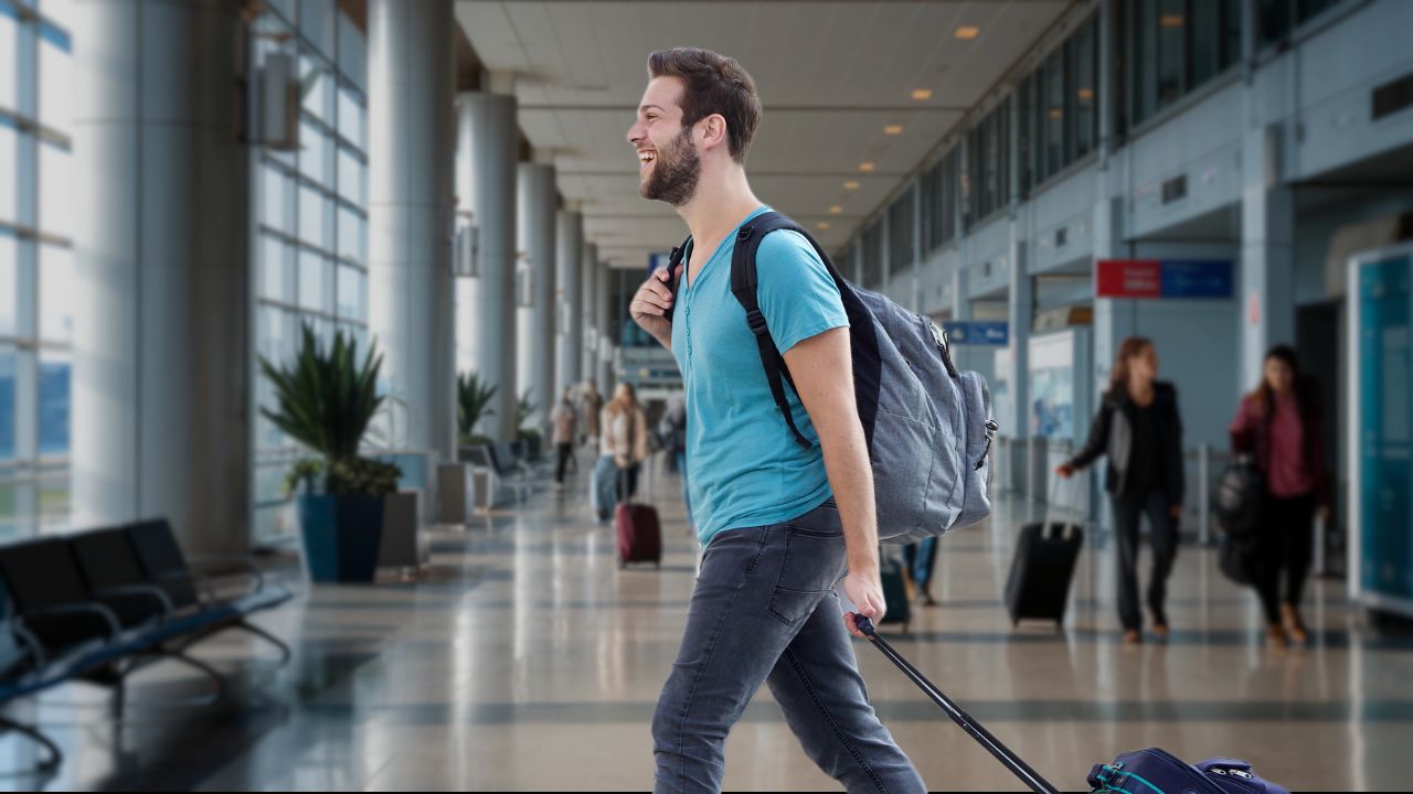 Man in airport with laptop backpack